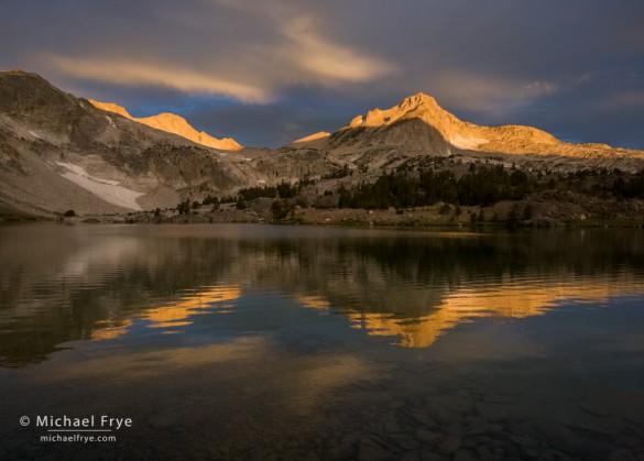 Sunrise illuminates North Peak from Greenstone Lake, Inyo NF, CA, USA