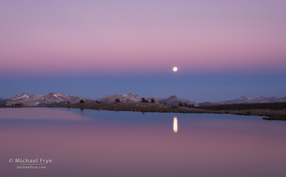 Moon setting over an alpine lake, Yosemite NP, June 23rd, 2013. Here, in summertime, the moon was setting to the west-southwest just before sunrise. The image was made only an hour after the moon was at its fullest, but since it was made from a high vantage point with such a low, open horizon to the west, the moon was still visible just before sunrise.