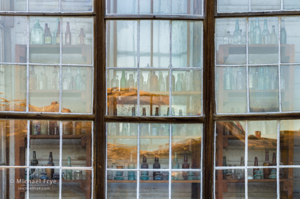 Window with bottles and late-afternoon reflections, Cain House, Bodie