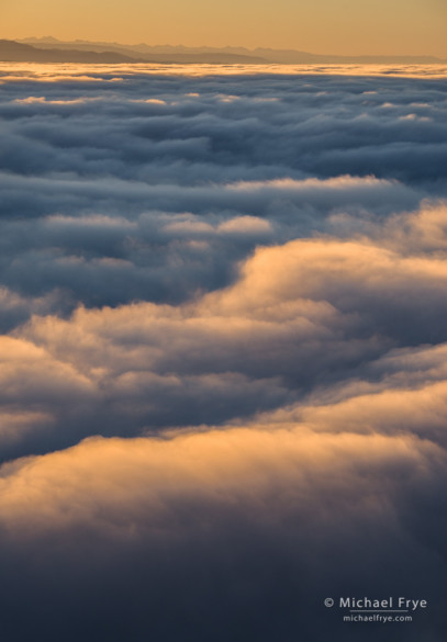 Fog and peaks of the Sierra Nevada from Mt. Bullion at sunrise, Mariposa County, CA, USA