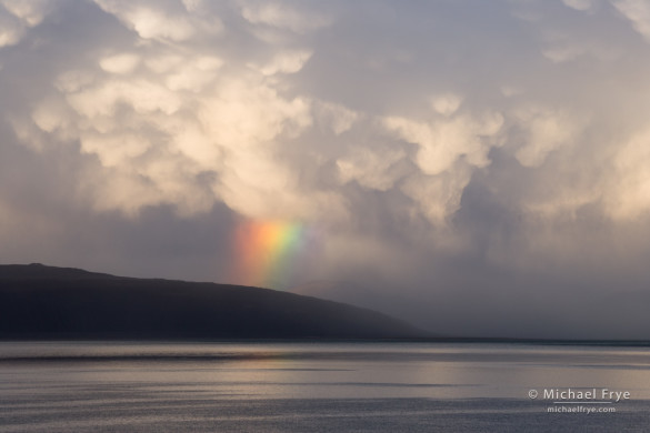 Rainbow and storm clouds over Black Point, Mono Lake, CA, USA