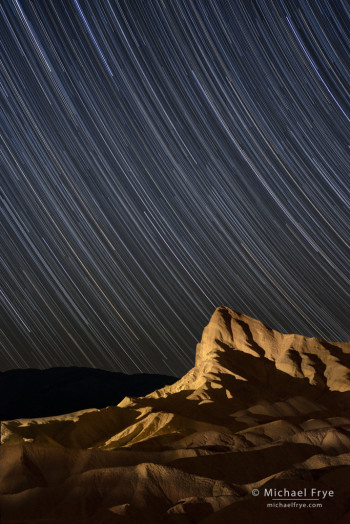Manly Beacon at night with star trails, Death Valley NP, CA, USA
