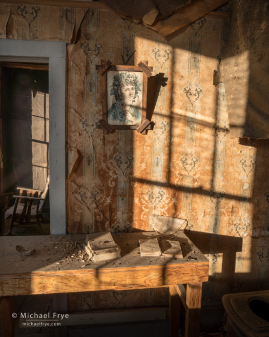 Books, portrait, and chair in the morgue, Bodie State Historic Park, CA, USA