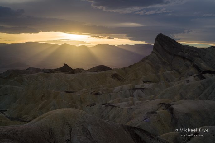 Sun setting behind Manly Beacon, Death Valley NP, CA, USA