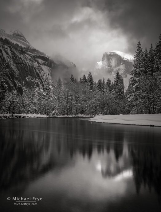 Half Dome, North Dome, and the Merced River with clouds, mist, and snow, Yosemite NP, CA, USA