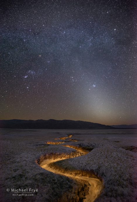 Stars, Orion, and zodiacal light over an eroded gully, Death Valley NP, CA, USA