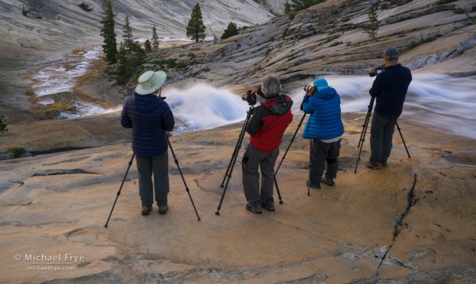 Photographers above a cascade, Yosemite NP, CA, USA