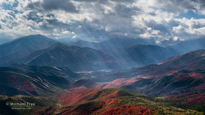 Sunbeams, mountains, and autumn maples, UT, USA