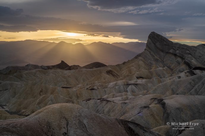 Sun setting behind Manly Beacon, Death Valley NP, CA, USA