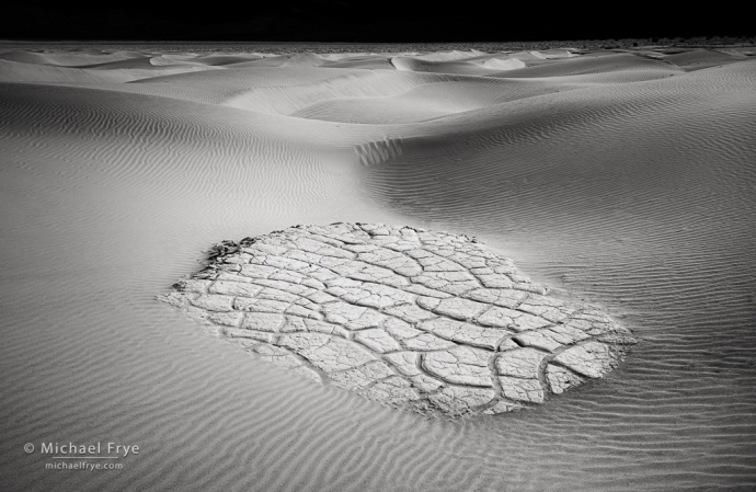 Clay pan amid sand dunes, Mojave Desert, CA, USA