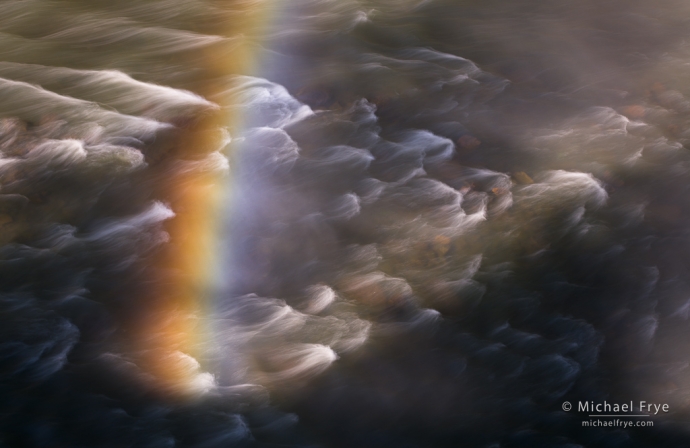 Rainbow and rapids below a waterfall, Idaho