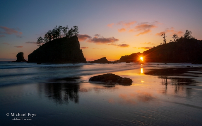 Sun setting through a natural bridge, Olympic NP, WA, USA