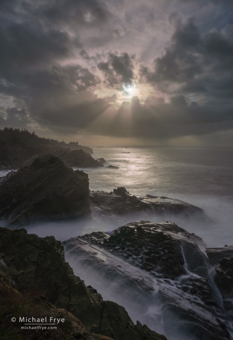 Sunbeams along a rocky coastline, OR, USA