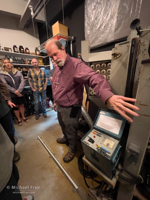 John Sexton showing Ansel Adams' massive horizontal enlarger, Carmel, CA, USA