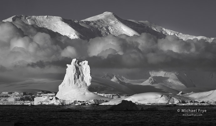 Iceberg and distant mountains, Antarctica