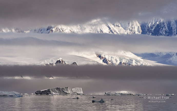 Mountains through layered clouds, Antarctica