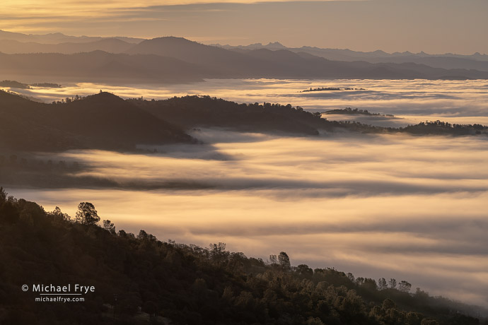 Fog and distant peaks at sunrise from the Sierra Nevada foothills, CA, USA