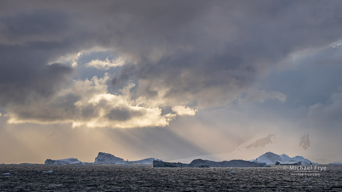Clouds, sunbeams, and icebergs, Antarctica